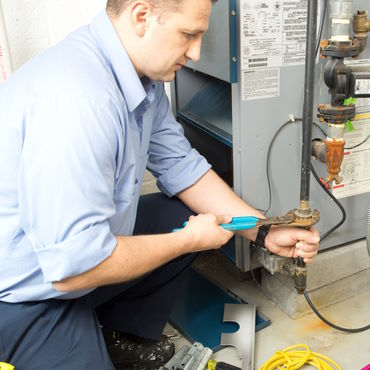 Technician installing new furnace